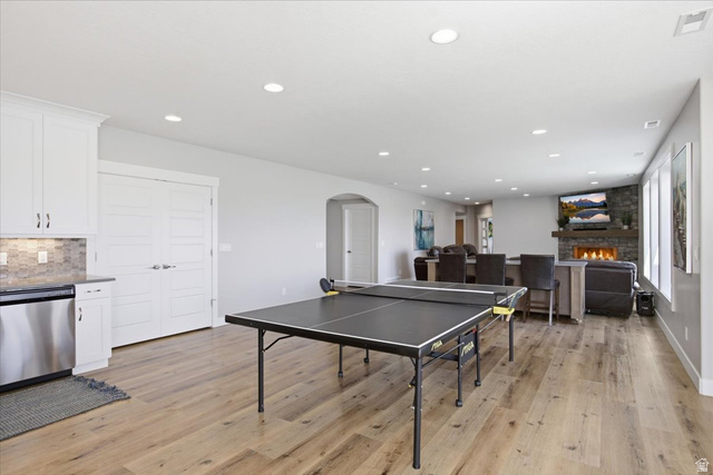 21 Pier Place Tooele, UT 84074 - Photo 57 of 112 Open-concept living area featuring wood-finish flooring, recessed lighting, and a stone-clad fireplace
