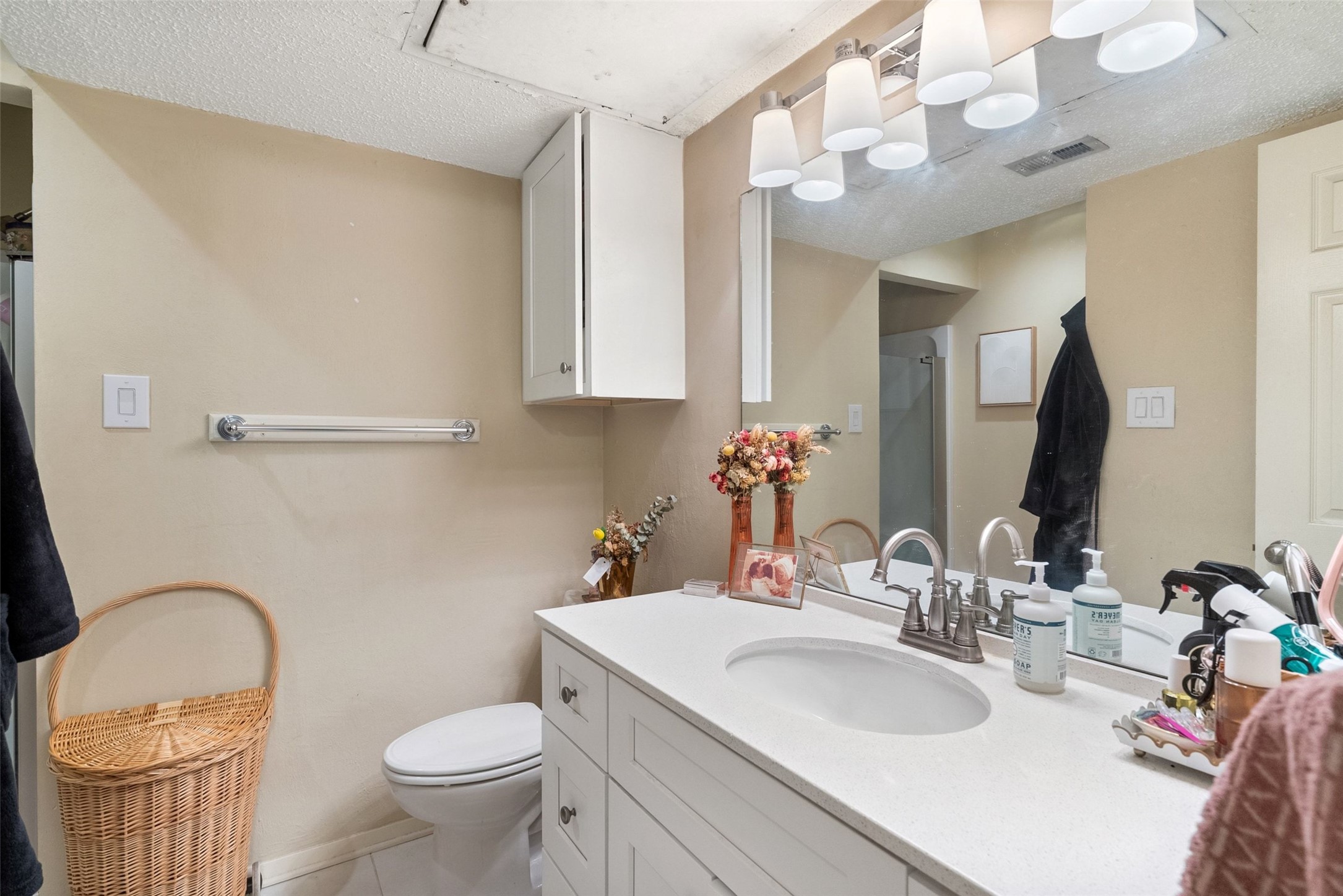 806 West 24th Street, Unit 328 Austin, TX 78705 - Photo 16 of 21 a bathroom with a granite countertop toilet sink and mirror