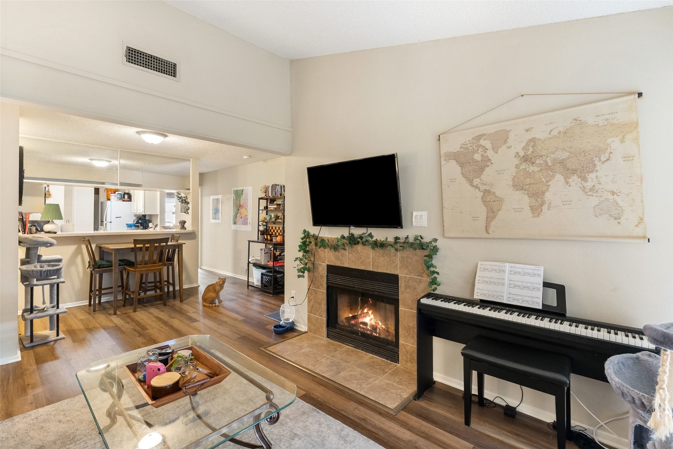 806 West 24th Street, Unit 328 Austin, TX 78705 - Photo 2 of 21 a living room with furniture a flat screen tv and a fireplace