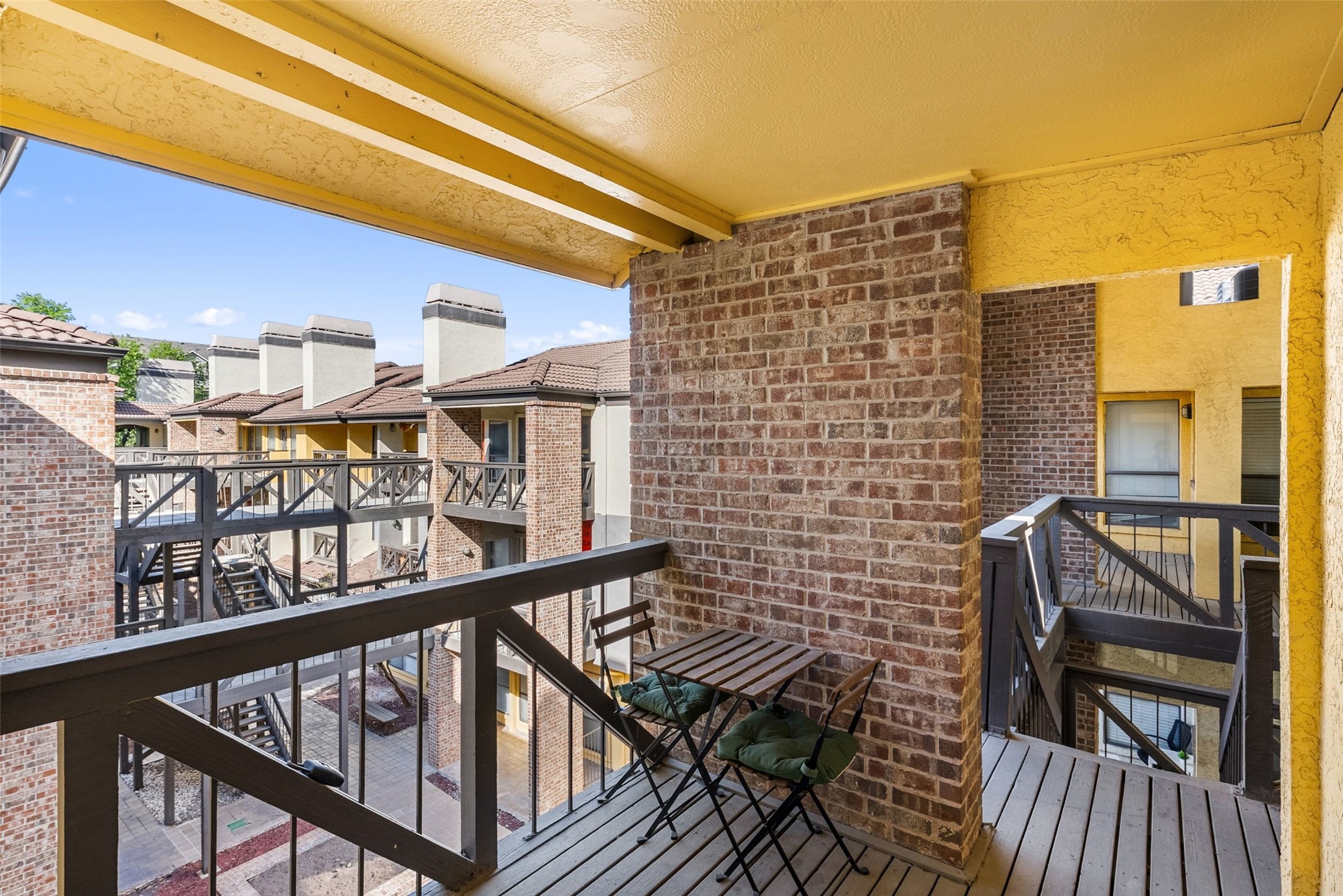 806 West 24th Street, Unit 328 Austin, TX 78705 - Photo 21 of 21 a view of balcony with wooden floor and outdoor seating