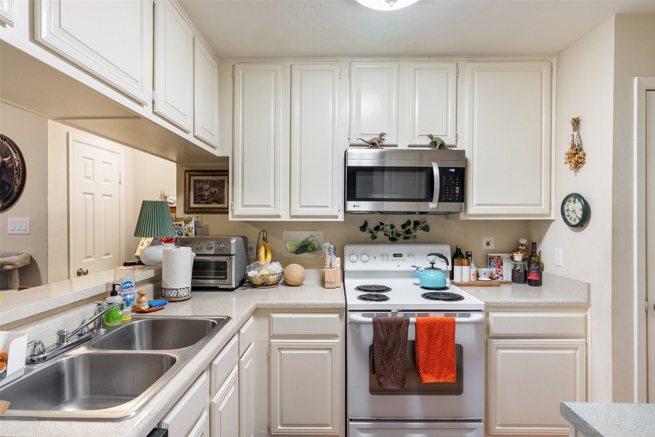 806 West 24th Street, Unit 328 Austin, TX 78705 - Photo 7 of 21 a kitchen with stainless steel appliances a sink a stove and a microwave