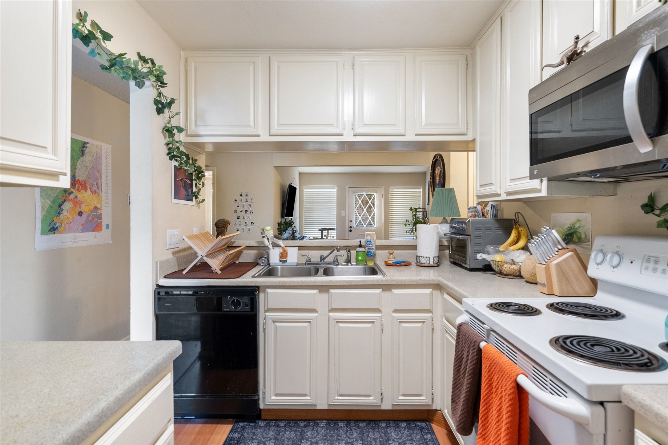 806 West 24th Street, Unit 328 Austin, TX 78705 - Photo 8 of 21 a kitchen with a sink stove and cabinets