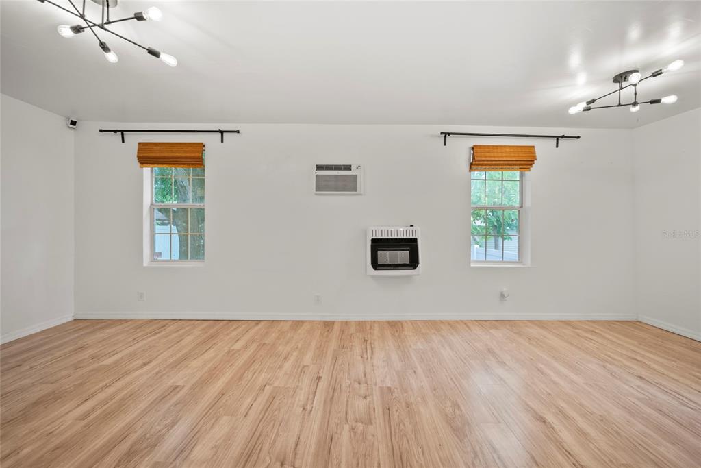 4622 Paloverde Drive New Port Richey, FL 34652 - Photo 12 of 22 an empty room with a window and wooden floor