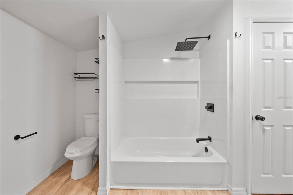 4622 Paloverde Drive New Port Richey, FL 34652 - Photo 20 of 22 a bathroom with a granite countertop toilet a sink and bathtub