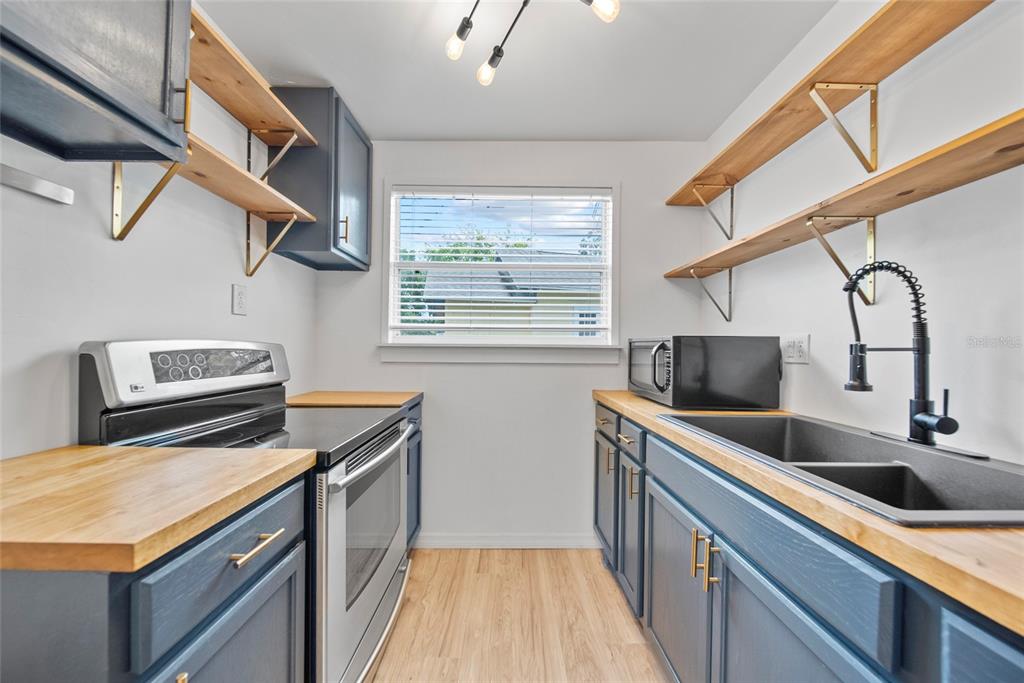 4622 Paloverde Drive New Port Richey, FL 34652 - Photo 4 of 22 a kitchen with stainless steel appliances granite countertop a sink and a stove