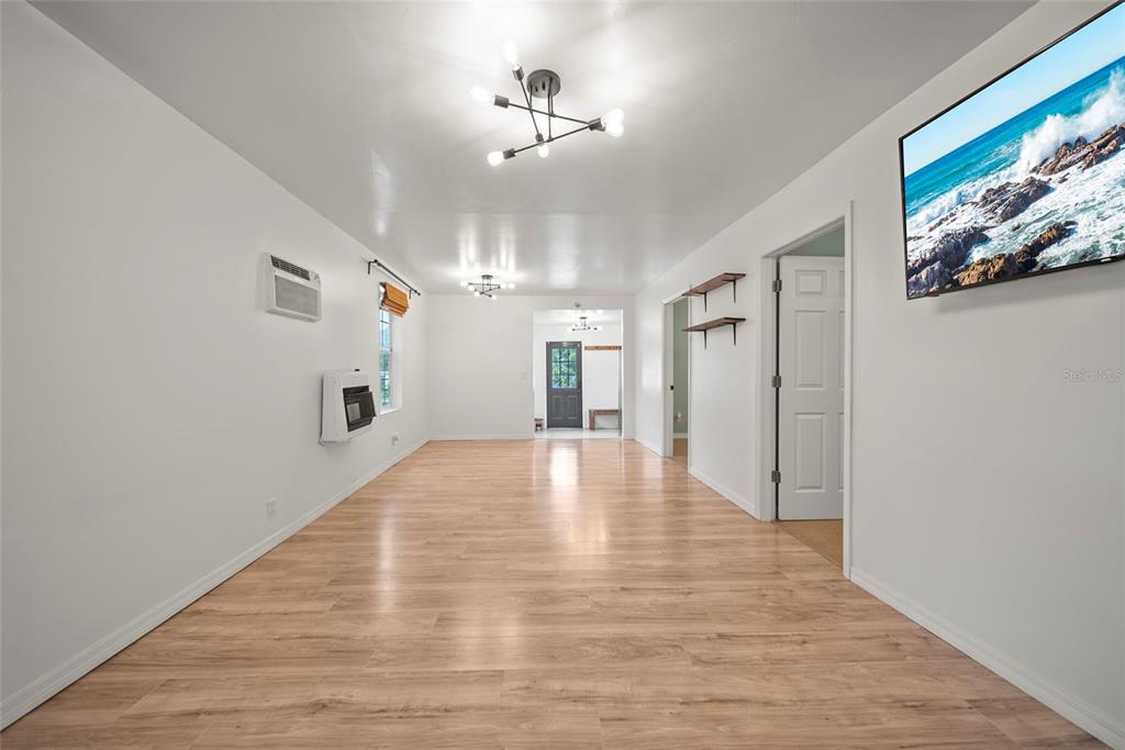 4622 Paloverde Drive New Port Richey, FL 34652 - Photo 5 of 22 a view of an empty room with wooden floor and a window