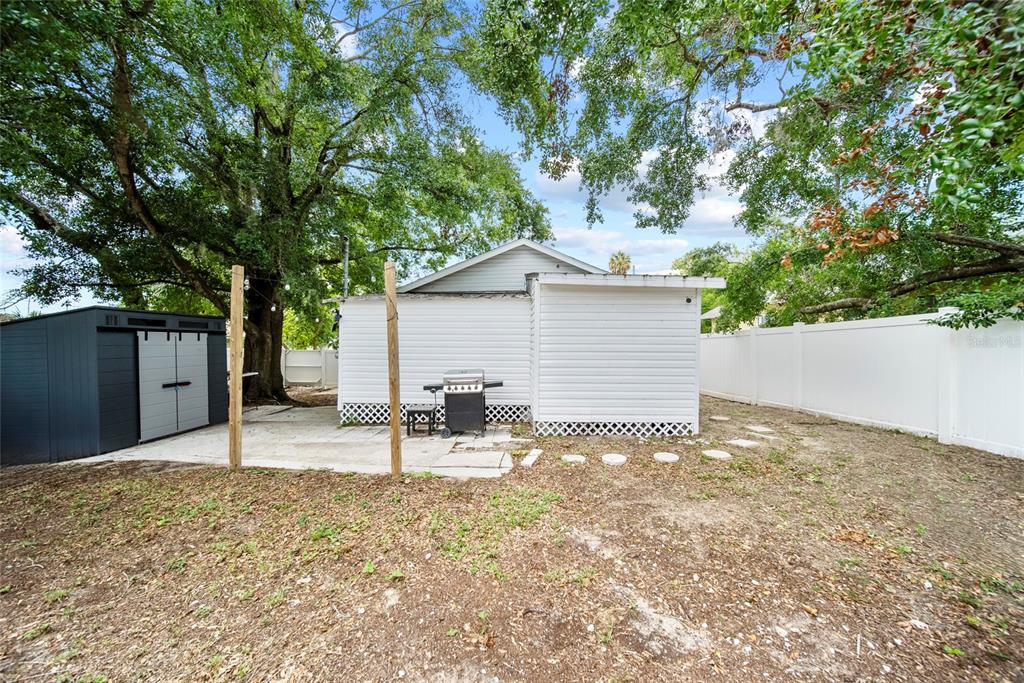 4622 Paloverde Drive New Port Richey, FL 34652 - Photo 6 of 22 a backyard of a house with table and chairs