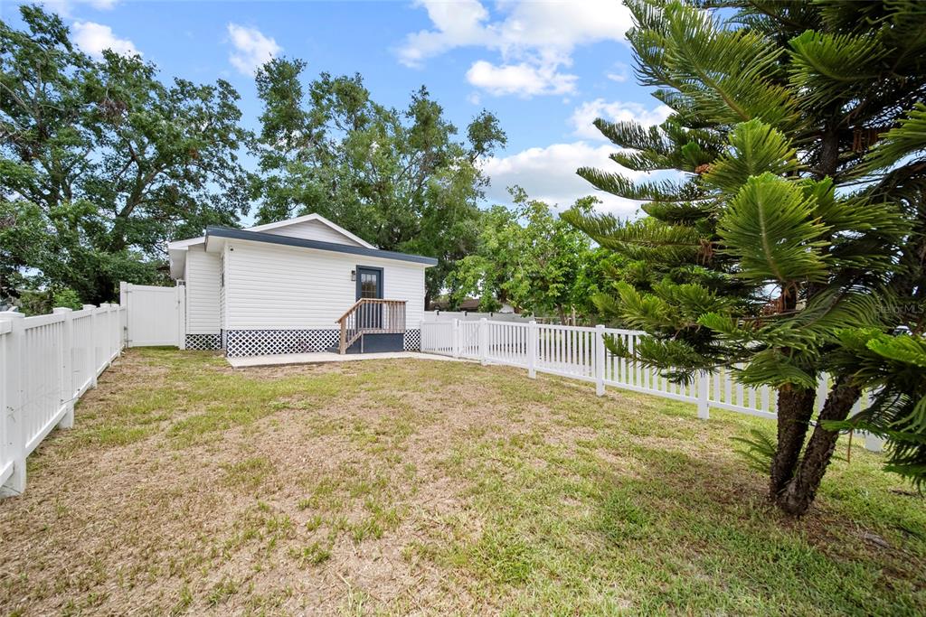 4622 Paloverde Drive New Port Richey, FL 34652 - Photo 7 of 22 a house with trees in front of it