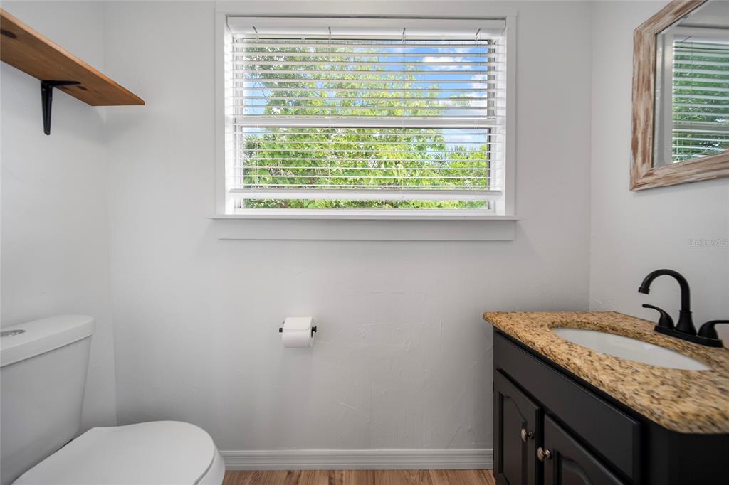 4622 Paloverde Drive New Port Richey, FL 34652 - Photo 8 of 22 a bathroom with a granite countertop sink toilet and a window