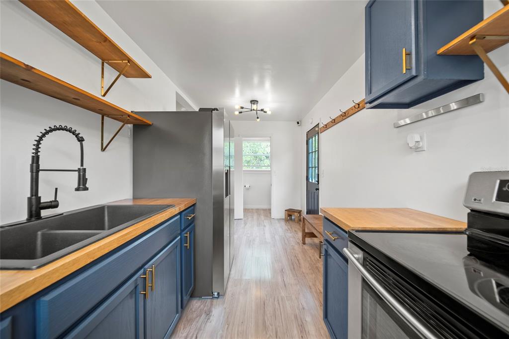 4622 Paloverde Drive New Port Richey, FL 34652 - Photo 10 of 22 a kitchen with stainless steel appliances granite countertop a sink and a stove