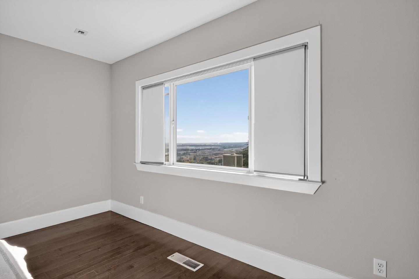 58 Hillcrest Road San Carlos, CA 94070 - Photo 73 of 105 a view of an empty room with wooden floor and a window