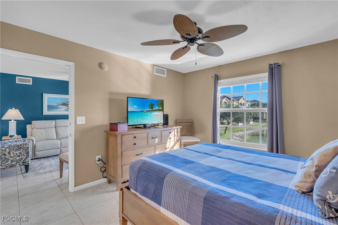 4109 Residence Drive, Unit 510 Fort Myers, FL 33901 - Photo 14 of 35 a bedroom with a bed and a television