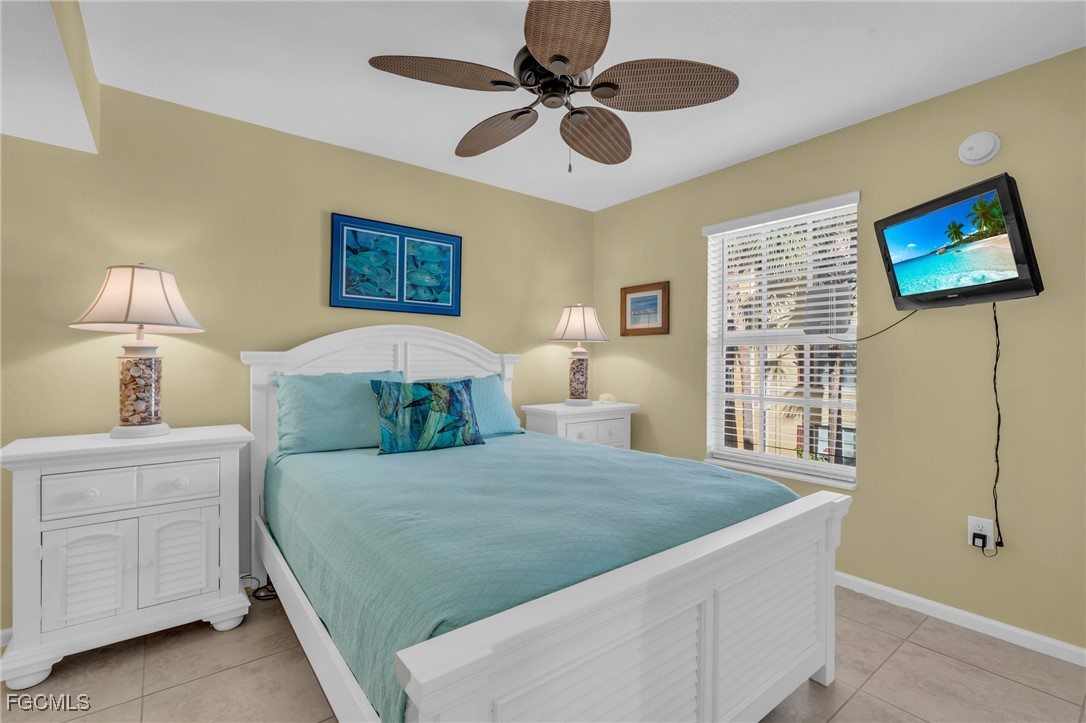 4109 Residence Drive, Unit 510 Fort Myers, FL 33901 - Photo 17 of 35 a bedroom with a bed and a chandelier