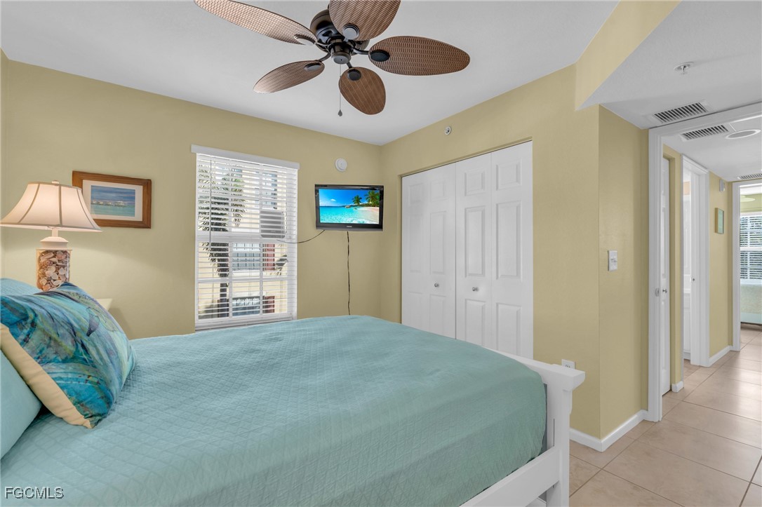 4109 Residence Drive, Unit 510 Fort Myers, FL 33901 - Photo 18 of 35 a bedroom with a bed and a chandelier