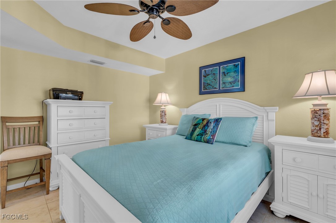 4109 Residence Drive, Unit 510 Fort Myers, FL 33901 - Photo 19 of 35 a bedroom with a bed and a chandelier