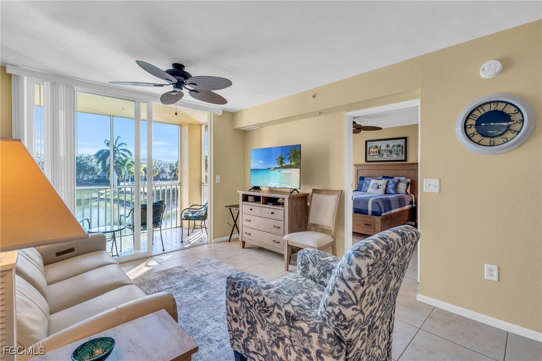 4109 Residence Drive, Unit 510 Fort Myers, FL 33901 - Photo 6 of 35 a living room with furniture a large window and a table