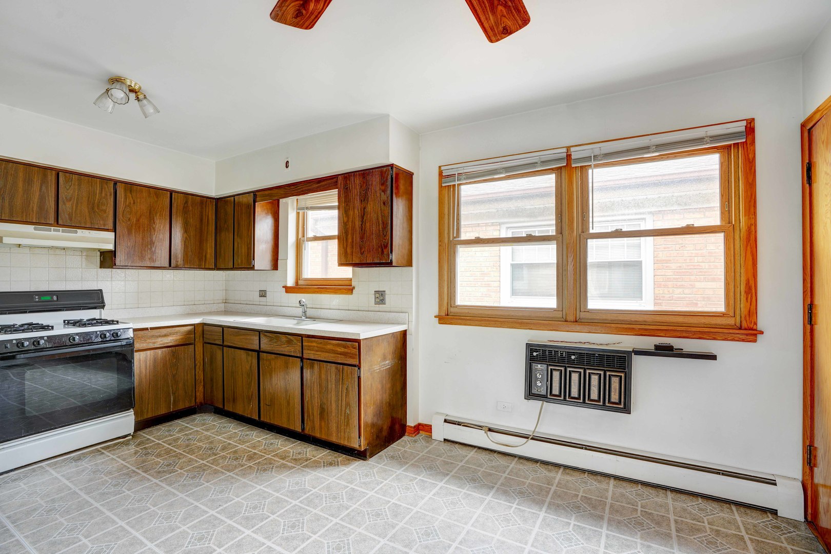 8444 West Gregory Street, Unit 3B Chicago, IL 60656 - Photo 3 of 9 a kitchen with stainless steel appliances granite countertop a stove a sink and a microwave