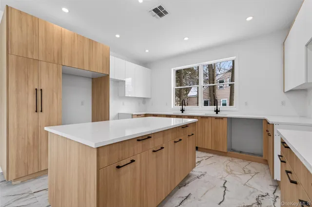 a kitchen with a sink a stove cabinets and a refrigerator