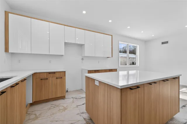 a kitchen with a sink window and cabinets