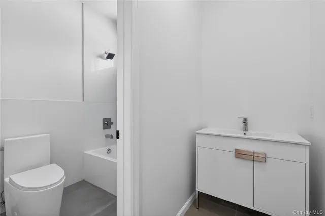 a bathroom with a toilet sink and shower