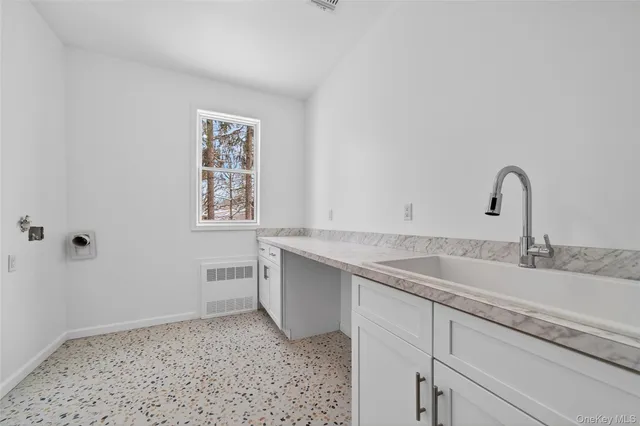 a kitchen with a sink and cabinets