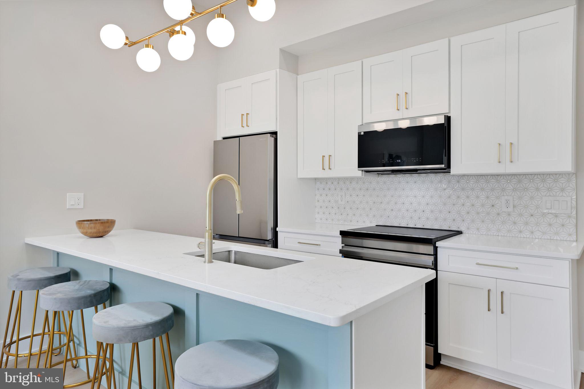 4019 9th Street Northeast, Unit 4 Washington, DC 20017 - Photo 14 of 32 a kitchen with stainless steel appliances a stove a sink and a microwave