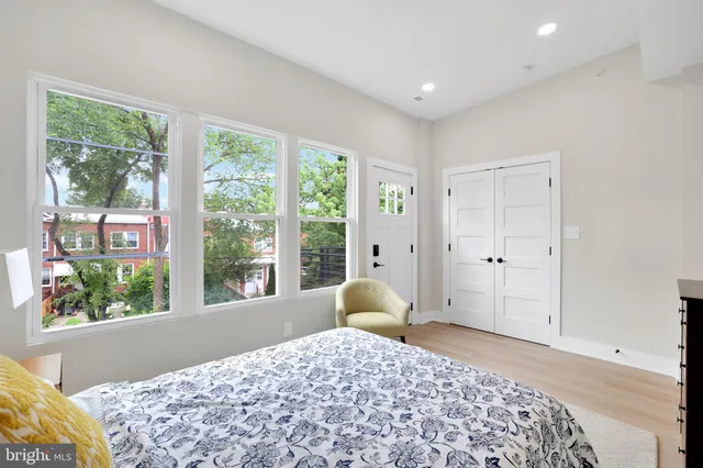 a bed sitting in a bedroom next to a window