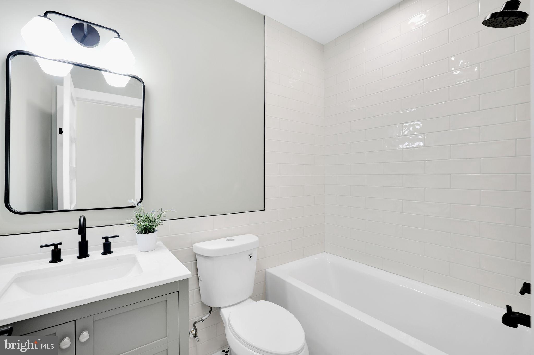 4019 9th Street Northeast, Unit 4 Washington, DC 20017 - Photo 28 of 32 a bathroom with a sink toilet and shower
