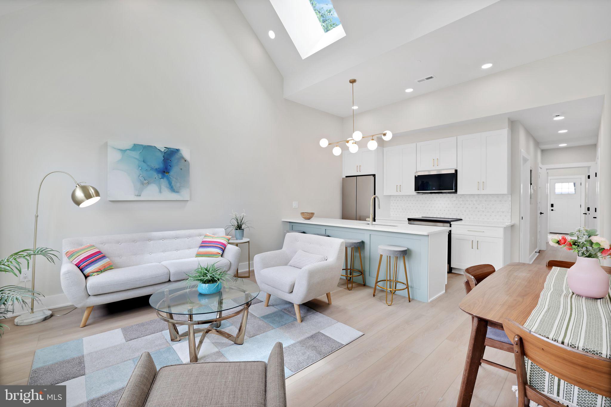 4019 9th Street Northeast, Unit 4 Washington, DC 20017 - Photo 3 of 32 a living room with fireplace furniture and a chandelier