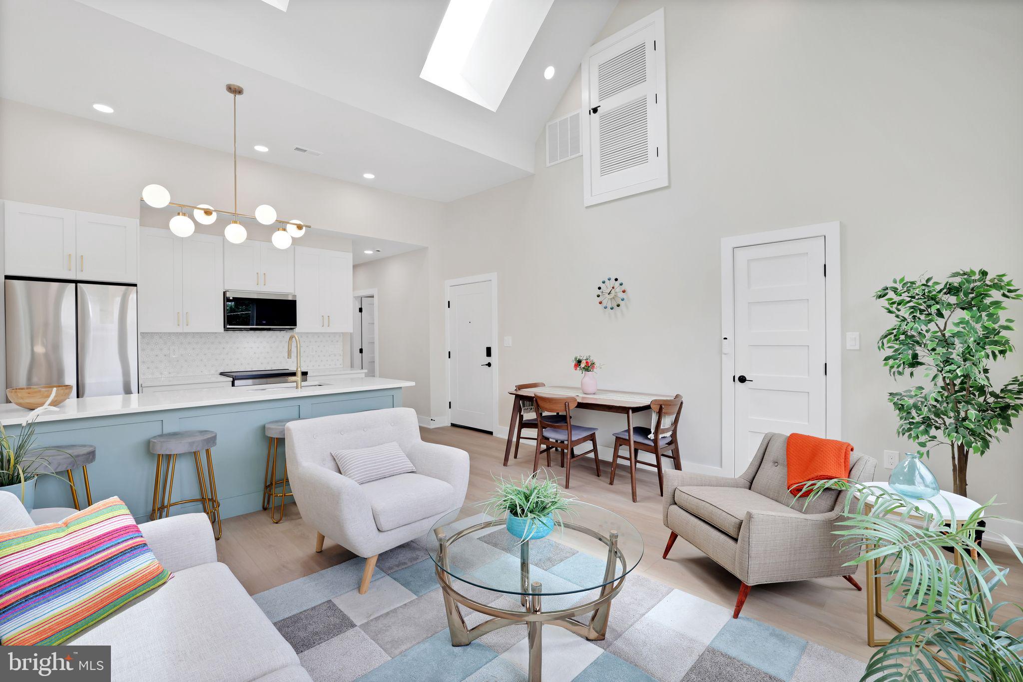 4019 9th Street Northeast, Unit 4 Washington, DC 20017 - Photo 6 of 32 a living room with furniture a chandelier and a flat screen tv