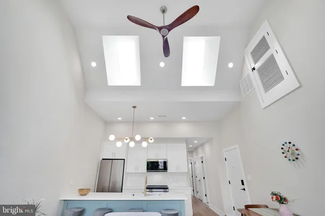 a view of kitchen with windows and ceiling fan