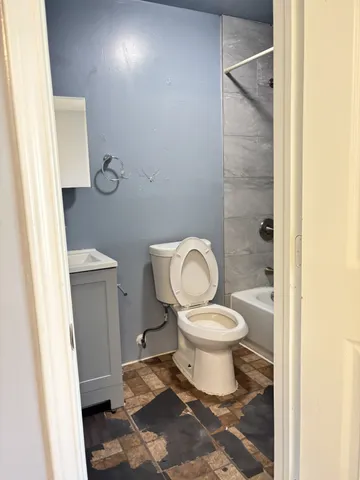 a bathroom with a toilet and a shower
