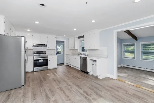 a kitchen with stainless steel appliances a refrigerator sink and stove top oven