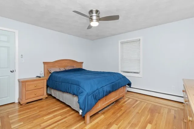 a bedroom with a bed and a ceiling fan