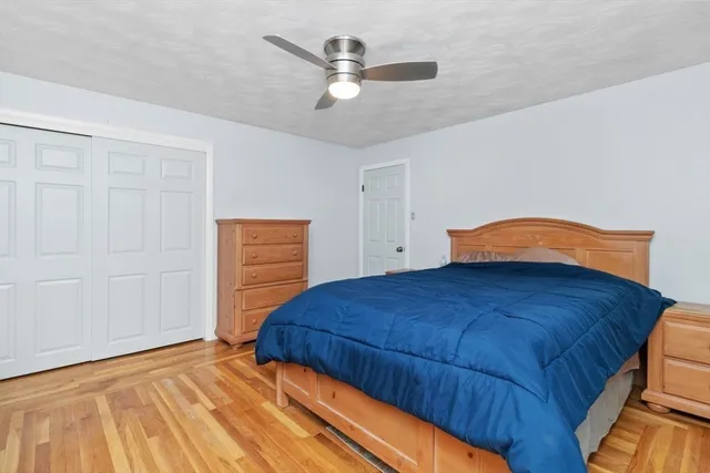 a bedroom with a bed and a ceiling fan