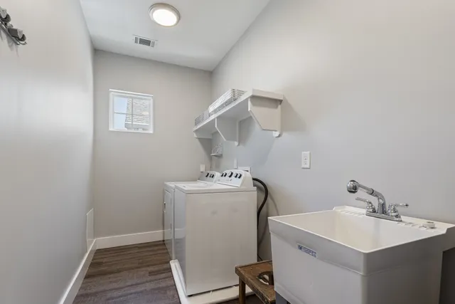 a utility room with sink dryer and washer