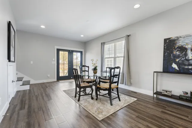 a dining room with furniture and wooden floor