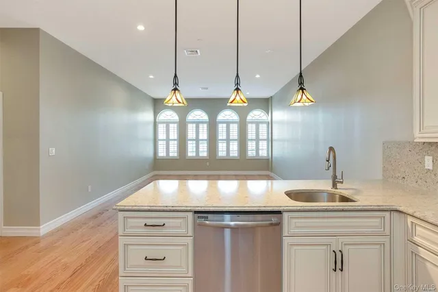 a kitchen with granite countertop a stove and a sink