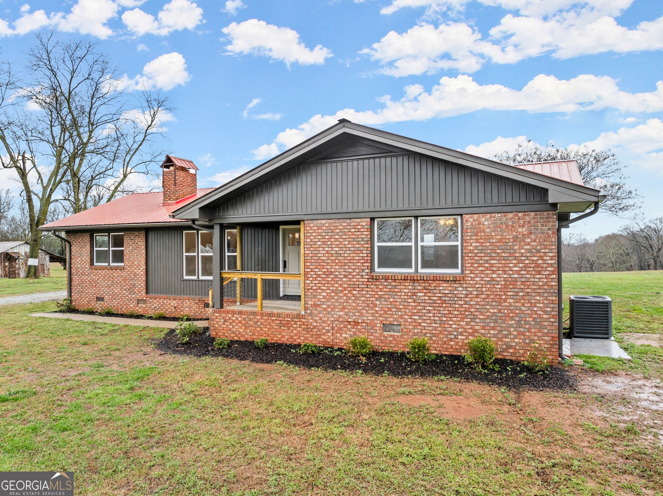 2571 Farmers Academy Road Carnesville, GA 30521 - Photo 1 of 1 a front view of a house with a garden