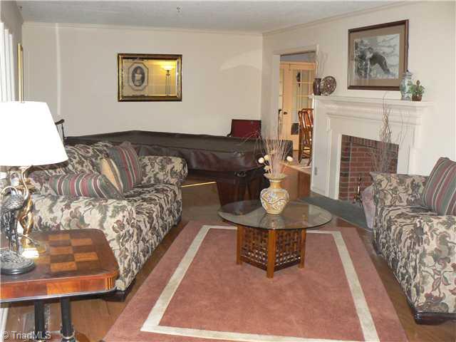 2444 Scott Mountain Road Asheboro, NC 27205 - Photo 2 of 16 Living Room. This Living Room is 13 X 20 10", has a fireplace and beautiful hardwood floors. Furniture was rearranged to allow an active game of table tennis. Tennis table may remain at acceptable offer. Picture taken from front door entry hall. DR in distance.