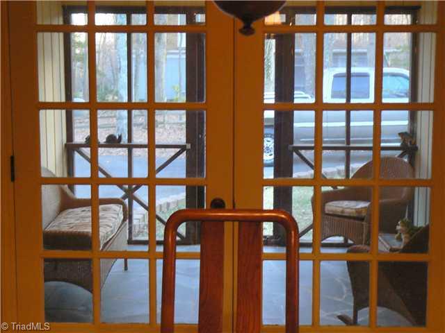 2444 Scott Mountain Road Asheboro, NC 27205 - Photo 13 of 16 Enclosed Porch. Here we are peering onto the 10 8" X 13 7" Screened Porch from the Dining Room. It appears smaller but the picture is deceiving. The door into the Dining Area/Kitchen is on the right and the Garage Door is on the left of porch.