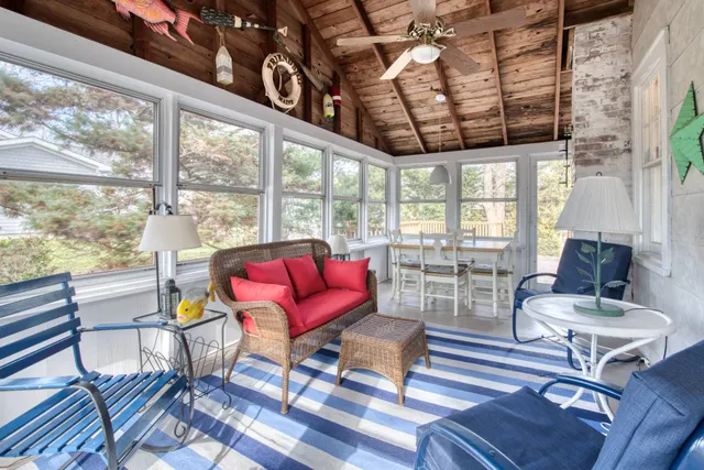 a living room with furniture and a floor to ceiling window