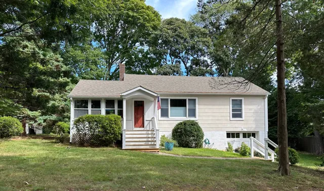 a front view of a house with a garden