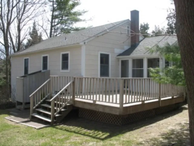 a view of a house with a wooden deck