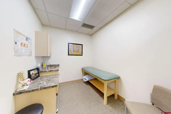 a room with granite countertop furniture and cabinets