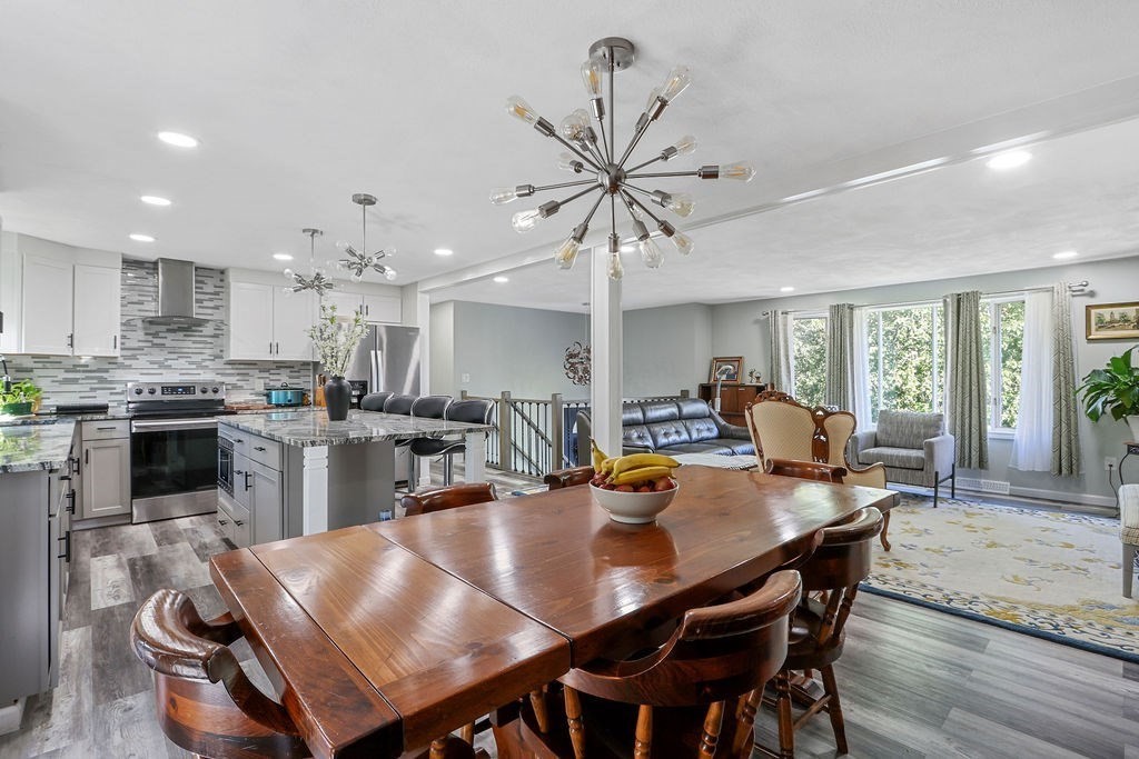 8 Given Drive Burlington, MA 01803 - Photo 11 of 42 a view of a dining room with furniture and wooden floor