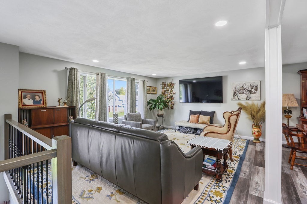 8 Given Drive Burlington, MA 01803 - Photo 3 of 42 a living room with furniture and a flat screen tv