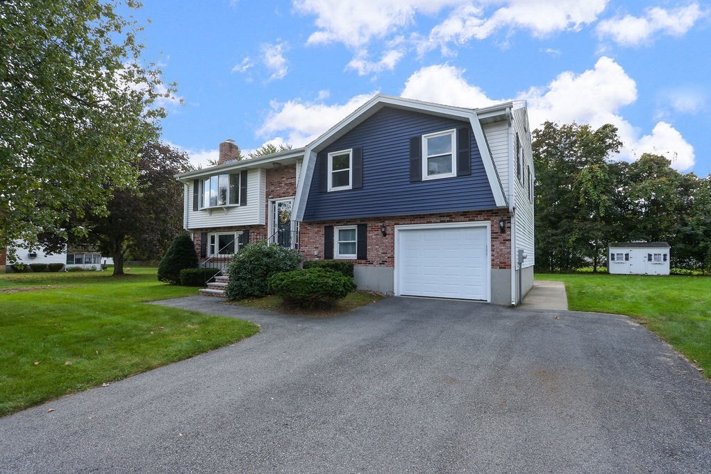 8 Given Drive Burlington, MA 01803 - Photo 41 of 42 a front view of a house with a yard and garage