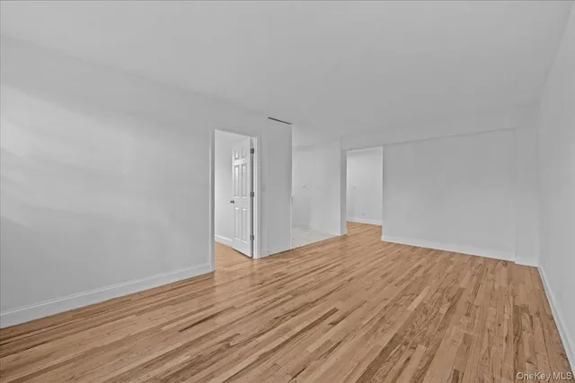 a view of an empty room and wooden floor