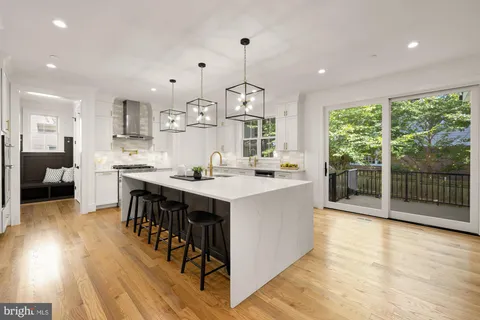 a living room with furniture and large windows